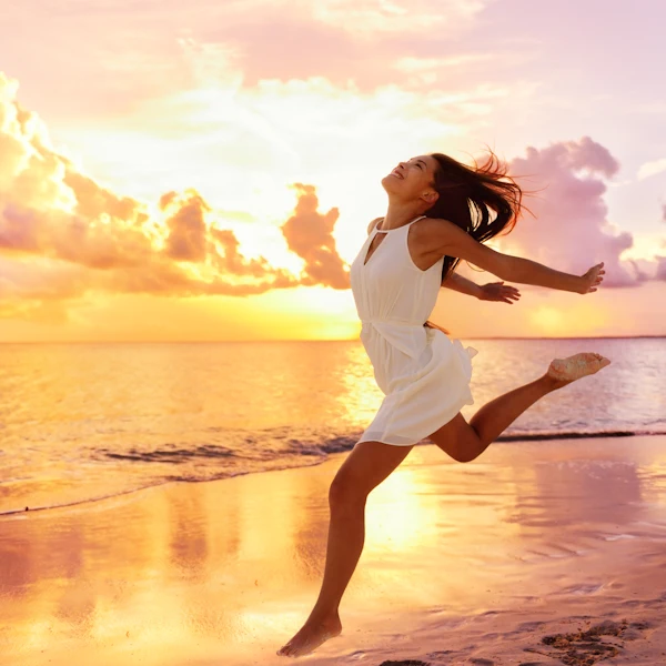 woman with freedom and joy like a strength running on beach at sunrise
