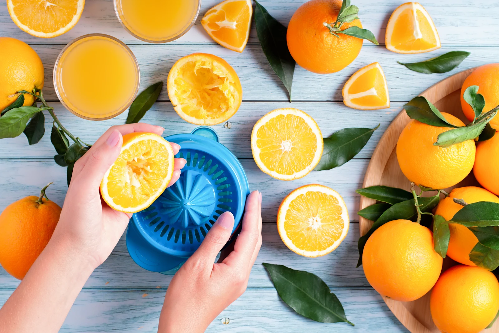 woman squeezing fresh oranges into orange juice